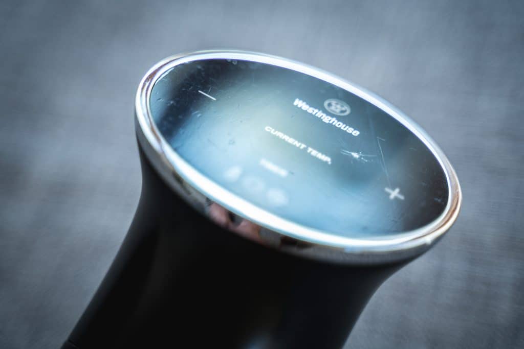 Close-up shot of the top part of the Westinghouse sous vide machine with light reflecting on it, revealing several scratches and imperfections on the plastic menu area.