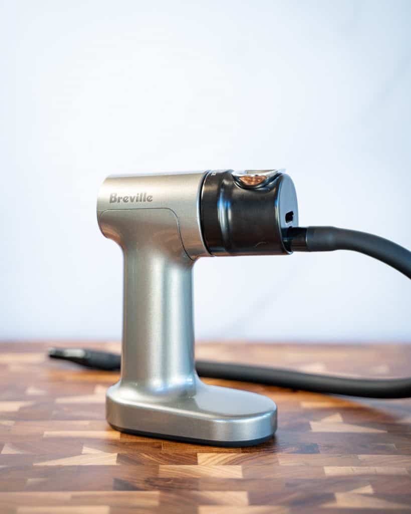 Close-up shot of the Breville smoking gun on a wooden board against a bright background.