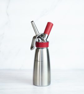Side view of the Isi Whipped Cream Dispenser against a light background